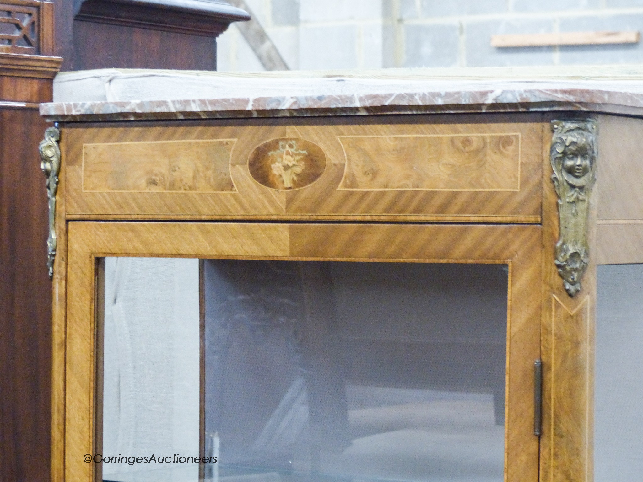 A late 19th century Louis XV style vitrine, with a shaped marble top above a single glazed panelled door, with applied cast metal mounts, W.78cm D.36cm H.175cm